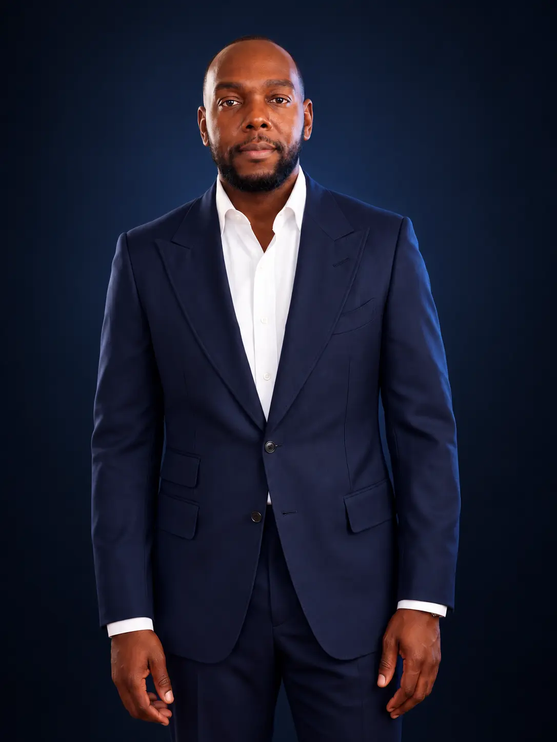Estimé Aristomene, Jr. in a navy suit